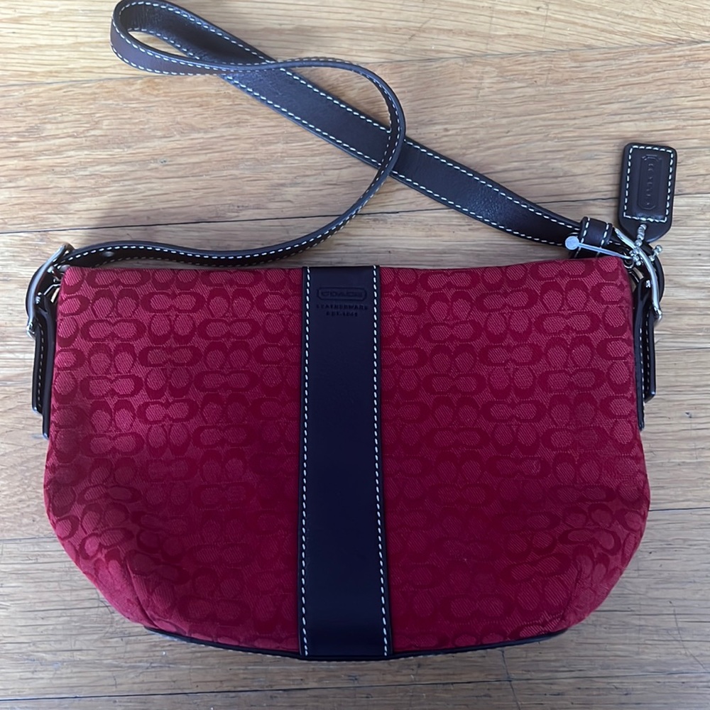 Red mini coach bag. Brown strap/strip down the front